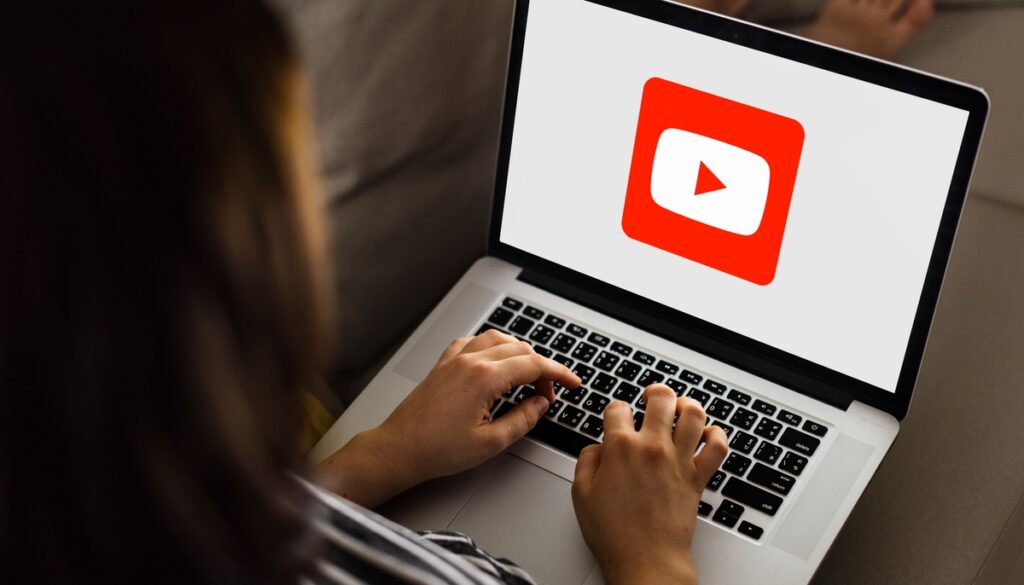 Woman using Youtube application on a laptop