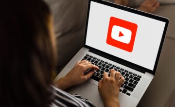 Woman using Youtube application on a laptop
